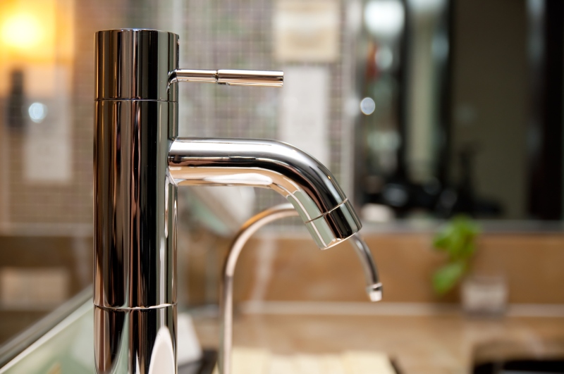 Leaking tap being repaired in Borehamwood